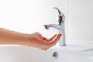 Hand,Under,Faucet,With,Low,Pressure,Water,Stream